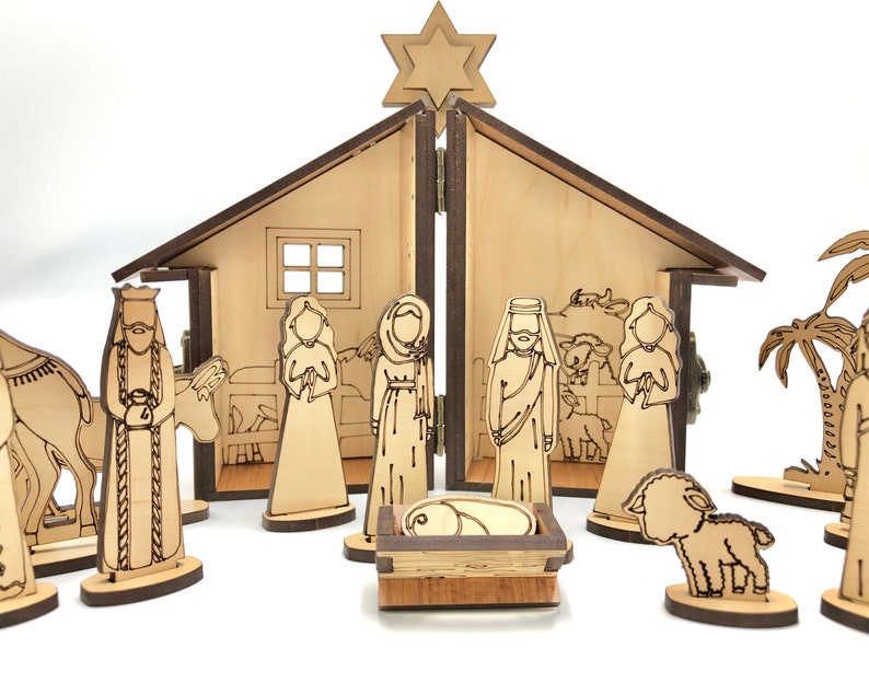 May include: A wooden nativity scene with a stable, a star, and figures of Mary, Joseph, baby Jesus, a donkey, a sheep, and palm trees.