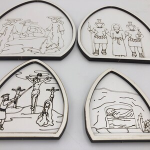 May include: Set of four black and white illustrations depicting scenes from the story of Jesus Christ. The illustrations are printed on white wooden plaques with a black border. The scenes include Jesus being crucified, Jesus being buried, Jesus appearing to Mary Magdalene, and Jesus appearing to the disciples.