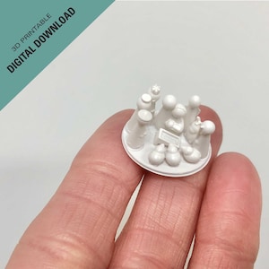 Puede incluir: Escena de la Natividad impresa en 3D en blanco con una estrella en la parte superior, que representa al niño Jesús, María, José y los tres reyes magos. Las figuras están dispuestas en círculo alrededor de un pesebre.