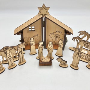 May include: A wooden nativity scene set with a stable, a star, a camel, a shepherd, a well, palm trees, and figures of Mary, Joseph, and baby Jesus.