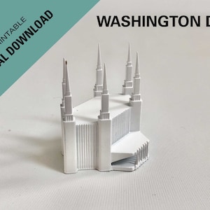 May include: A white 3D printed model of a building with multiple spires. The model is on a white surface with a striped pattern. The text "WASHINGTON DC" is visible in the background.
