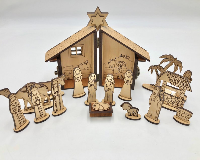 May include: A wooden nativity scene set with a stable, a star, a camel, a shepherd, a well, palm trees, and figures of Mary, Joseph, and baby Jesus.