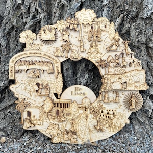May include: A wooden circular wall art piece depicting scenes from the Bible. The art features a circular design with the words "He Lives" in the center. The scenes include the Last Supper, the Garden of Gethsemane, the crucifixion, and the resurrection.