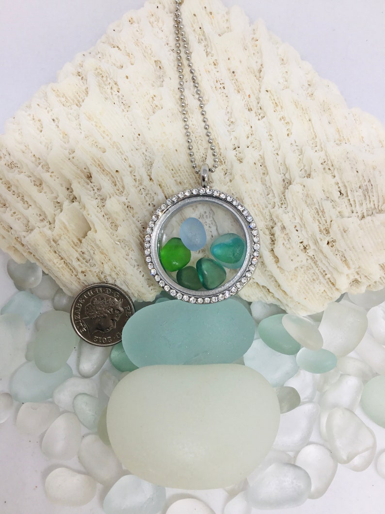 Memory locket with pieces of seahams historic seaglass in shades of blue and green