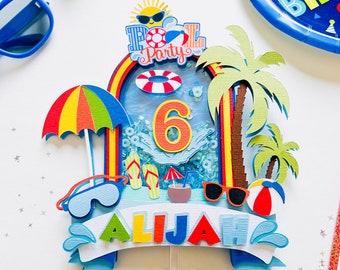 May include: A colorful cake topper with a pool party theme. It features a blue pool with a life preserver, flip flops, a coconut drink, sunglasses, and palm trees. The number 6 is in the center of the pool and the name "Aliyah" is on a blue banner.