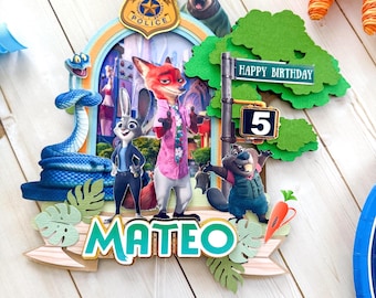 May include: A vibrant Zootopia cake topper with Nick Wilde, Judy Hopps, and other characters. The topper includes the text "HAPPY BIRTHDAY" and "MATEO", with a number 5. The design incorporates a police badge and a street sign.