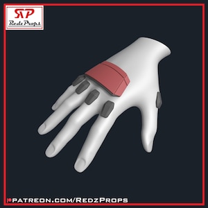 May include: A white 3D printed hand model with a red and gray glove. The glove has a rectangular panel on the back of the hand and several small, round, gray panels on the fingers.