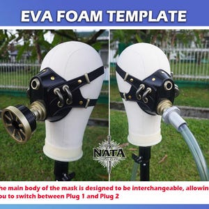 K&ouml;nnte beinhalten: Schwarze und goldfarbene EVA-Schaummaske mit verstellbaren Riemen, pr&auml;sentiert auf einem wei&szlig;en Schaufensterkopf. Die Maske hat einen kreisf&ouml;rmigen Filter und ist mit "EVA FOAM TEMPLATE" beschriftet. Der Text unten besagt, dass die Maske austauschbar ist.