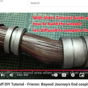 May include: A brown staff prop with a textured wood-grain finish and two silver-colored metallic rings. The image includes red text that reads: With Video Tutorial Guide you how to build the weapon less diffucult to complete the staff.