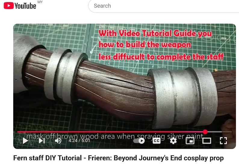May include: A brown staff prop with a textured wood-grain finish and two silver-colored metallic rings. The image includes red text that reads: With Video Tutorial Guide you how to build the weapon less diffucult to complete the staff.