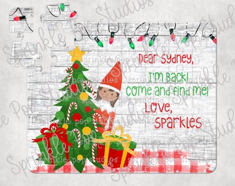 May include: A whitewashed wood background with red and white checked fabric at the bottom. A Christmas elf is standing next to a decorated Christmas tree with presents underneath. The text reads "Dear Sydney, I'm back! Come and find me! Love, Sparkles".