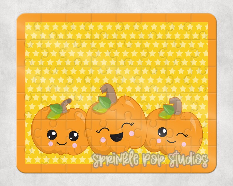 May include: A yellow jigsaw puzzle with a background of yellow stars. The puzzle features three orange pumpkins with cute faces. The text "Sprinkle Pop Studios" is at the bottom of the puzzle.