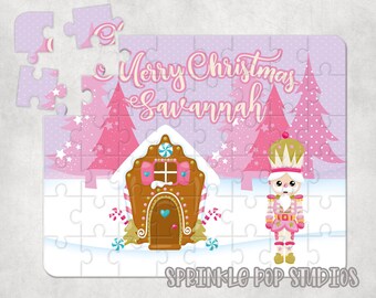 May include: A pink and white Christmas jigsaw puzzle featuring a gingerbread house, a nutcracker, and the text "Merry Christmas Savannah".
