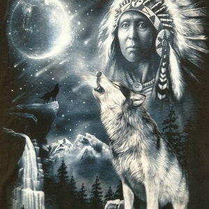 May include: A Native American man in traditional headdress stands with a wolf howling at the moon. The scene is set against a backdrop of a starry night sky, a waterfall, and mountains.