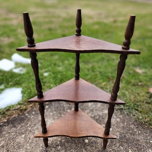 May include: A white ceramic mug with a black handle and the text "But first, coffee" in a handwritten style. The mug is on a white surface. The mug is 4 inches tall.