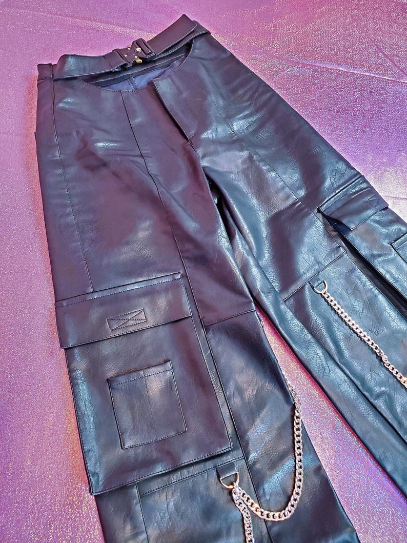 May include: Black leather cargo pants with a silver chain detail and multiple pockets.