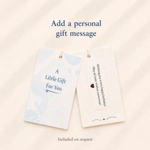 May include: Two rectangular gift tags with rounded corners. The left tag is light blue with white abstract shapes and the text A Little Gift For You. The right tag is cream with a white sticker featuring the text Wishing you a very happy birthday! May all your wishes come true! and a small red heart icon.