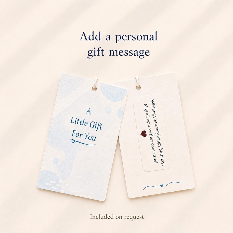 May include: Two rectangular gift tags with rounded corners. The left tag is light blue with white abstract shapes and the text A Little Gift For You. The right tag is cream with a white sticker featuring the text Wishing you a very happy birthday! May all your wishes come true! and a small red heart icon.