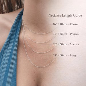 May include: A necklace length guide showing four silver chain necklaces of varying lengths. The guide indicates lengths of 16 inches (choker), 18 inches (princess), 20 inches (matinee), and 24 inches (long). The text "Necklace Length Guide" is at the top.