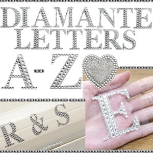 May include: Silver diamante letters, A-Z, R&S, and a heart shape. The letters are on a white background and the heart is on a clear background.