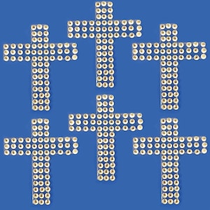 May include: Five silver rhinestone cross iron-on patches. Each cross is made of small, round rhinestones.