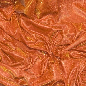 1m Lurex moonlight orange glittery slight Stretch fabric 58"