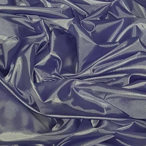 May include: A close-up of a deep purple satin fabric with a smooth, silky texture. The fabric is folded and draped, creating a luxurious and elegant look.