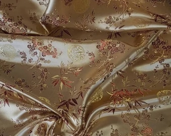 May include: Gold fabric with a repeating pattern of red and gold bamboo and cherry blossoms.