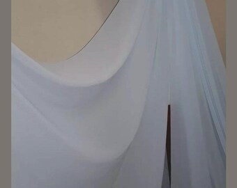 May include: A light blue sheer fabric draped over a mannequin. The fabric is soft and flowing, with a delicate texture.
