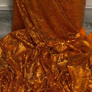 1m burnt Orange sequin   fabric 58" wide