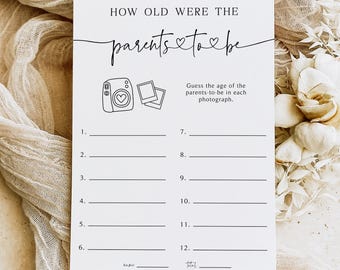 May include: A white card with the text "HOW OLD WERE THE parents to be" in black script. The card includes prompts to guess the age of the parents-to-be in photographs, with numbered lines and illustrations of a camera and photos.