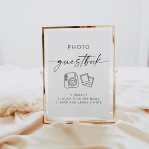 Create a fun and memorable experience for your guests with this stylish Photo Guest Book Sign, perfect for your Polaroid guest book table or instant‑camera station. This printable sign invites guests to snap a photo, shake it, and leave a note, helping you capture candid moments and heartfelt messages you’ll treasure long after the wedding day.