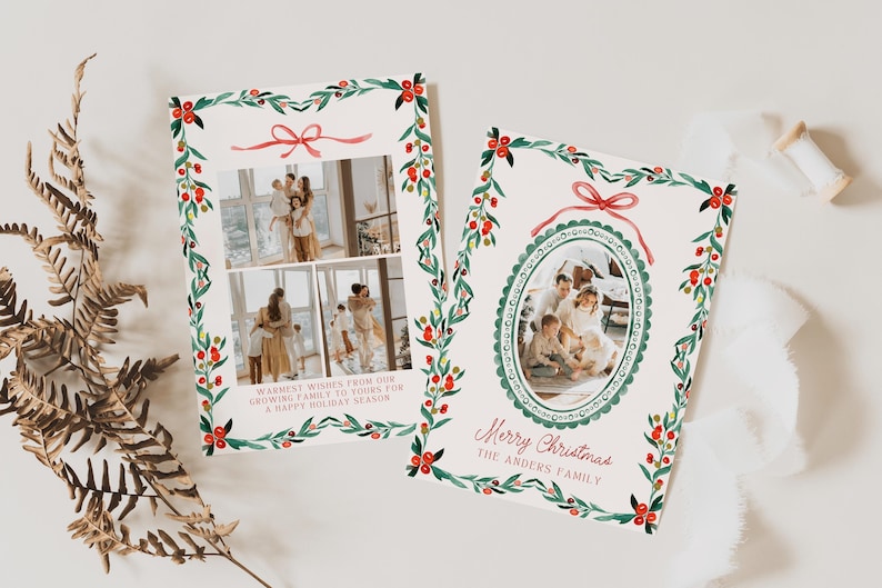 May include: Two Christmas cards with family photos, adorned with watercolor illustrations of holly and red bows. One card features two photos, the other an oval photo. Text includes "Warmest wishes" and "Merry Christmas".