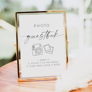 Create a fun and memorable experience for your guests with this stylish Photo Guest Book Sign, perfect for your Polaroid guest book table or instant‑camera station. This printable sign invites guests to snap a photo, shake it, and leave a note, helping you capture candid moments and heartfelt messages you’ll treasure long after the wedding day.