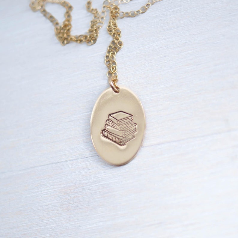 image of gold-filled necklace stamped with a stack of books