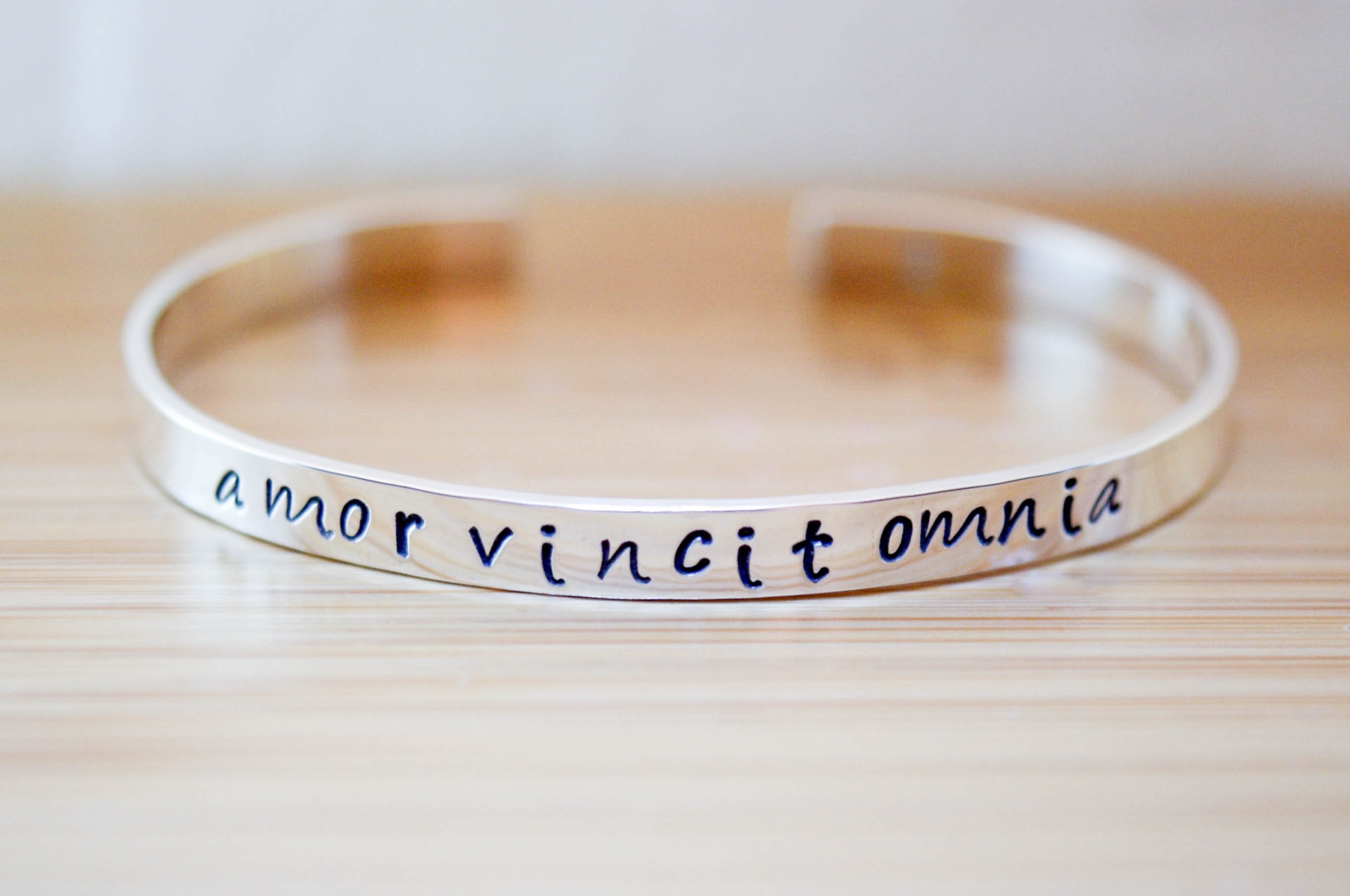 Amor vincit omnia best sale bracelet