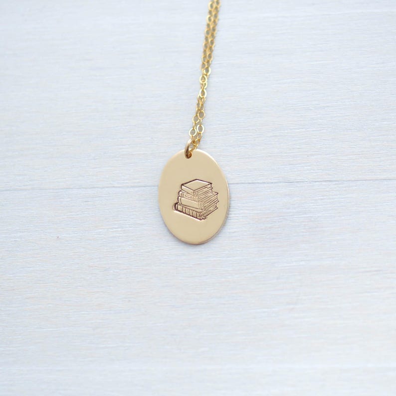 image of gold-filled literary gift necklace stamped with a stack of books