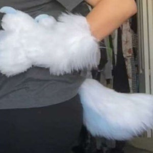 May include: A pair of white furry paws with blue claws and a matching white furry tail.