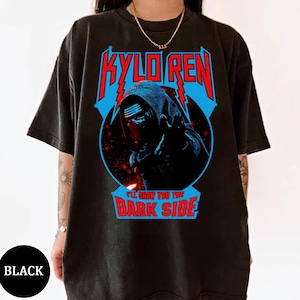 May include: Black t-shirt featuring a graphic of Kylo Ren with the text "KYLO REN" in red and blue, and "I'LL SHOW YOU THE DARK SIDE" in red. The design is set against a blue lightning bolt background.