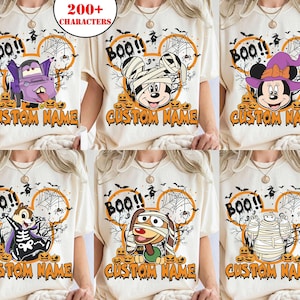 May include: A collection of six off-white t-shirts featuring various Halloween-themed cartoon characters, including a vampire truck, a mummy mouse, a witch mouse, a skeleton chipmunk, a mummy dog, and a mummy robot, with the text BOO! and CUSTOM NAME.