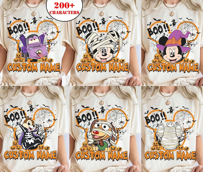 May include: A collection of six off-white t-shirts featuring various Halloween-themed cartoon characters, including a vampire truck, a mummy mouse, a witch mouse, a skeleton chipmunk, a mummy dog, and a mummy robot, with the text BOO! and CUSTOM NAME.