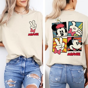 May include: A beige t-shirt with a graphic of Minnie Mouse on the front and a graphic of Minnie Mouse in four squares on the back. The shirt says "Minnie" on the front and back.