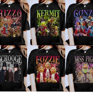 May include: Black t-shirts displaying Muppets characters with their names in bold, stylized fonts. The designs include Rizzo, Kermit, Gonzo, Scrooge, Fozzie, and Miss Piggy, each set against a backdrop of lightning.