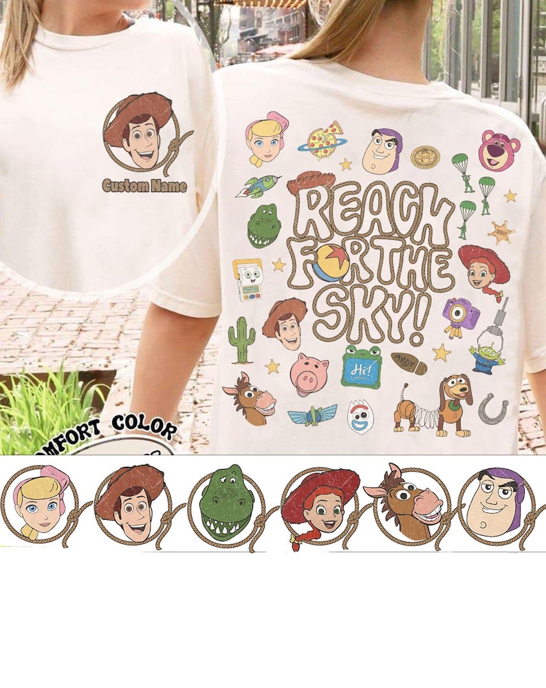May include: A cream-colored t-shirt featuring a small graphic of Woody on the front with the text Custom Name. The back displays a large collage of Toy Story characters and icons with the text REACH FOR THE SKY! in a rope-style font.