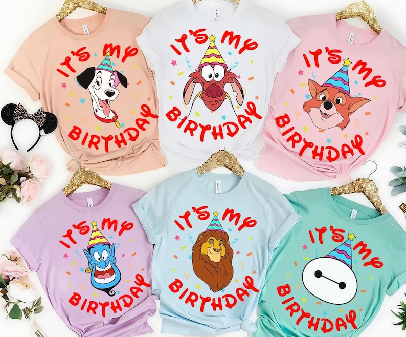 May include: Six short-sleeved crew neck t-shirts in peach, white, pink, lavender, light blue, and mint green. Each shirt features a cartoon character wearing a colorful party hat and the red text "IT'S MY BIRTHDAY" surrounded by confetti.