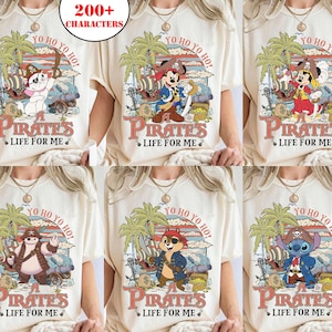May include: Cream-colored t-shirts featuring various cartoon characters dressed as pirates. Each shirt has a unique design with the text "Pirates Life For Me" and "Yo Ho Yo Ho!" in a vintage style. The designs include palm trees and pirate-themed elements.