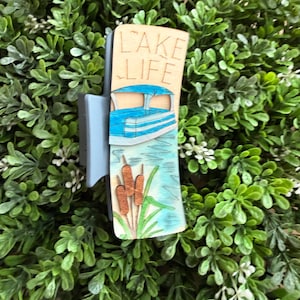 May include: A white ceramic mug with a black handle and the text "But First, Coffee" in a black, bold font. The mug is on a white surface. The mug is approximately 4 inches tall.