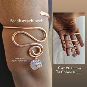 May include: A copper wire arm cuff with a white crystal stone attached. The cuff is shaped like a snake and has a spiral design. The text "Beaditwearitloveit" is visible in the image. The text "Pure Copper Crystal Arm Cuffs" is also visible. The text "Over 20 Stones To Choose From" is visible in the image.