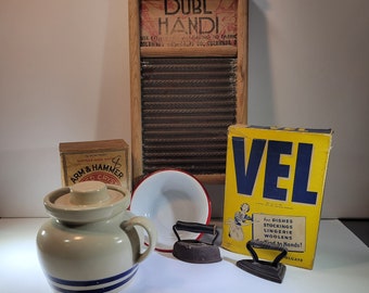 Choice of assorted vintage laundry room decor items, washing soaps, laundry soap crock, SAD irons, enamel bowl, washboard