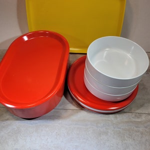 Ingrid stacking dishes, replacement pieces, Oblique tray, Ingrid lidded bowl, red, white, and yellow plastic dishes